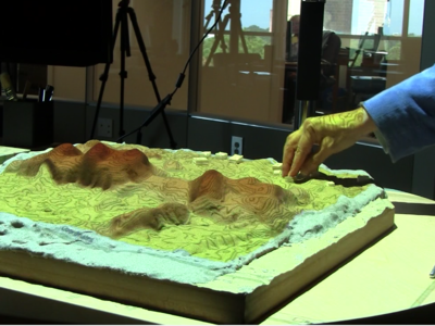 Carved model of Jockey's Ridge with layer of sand